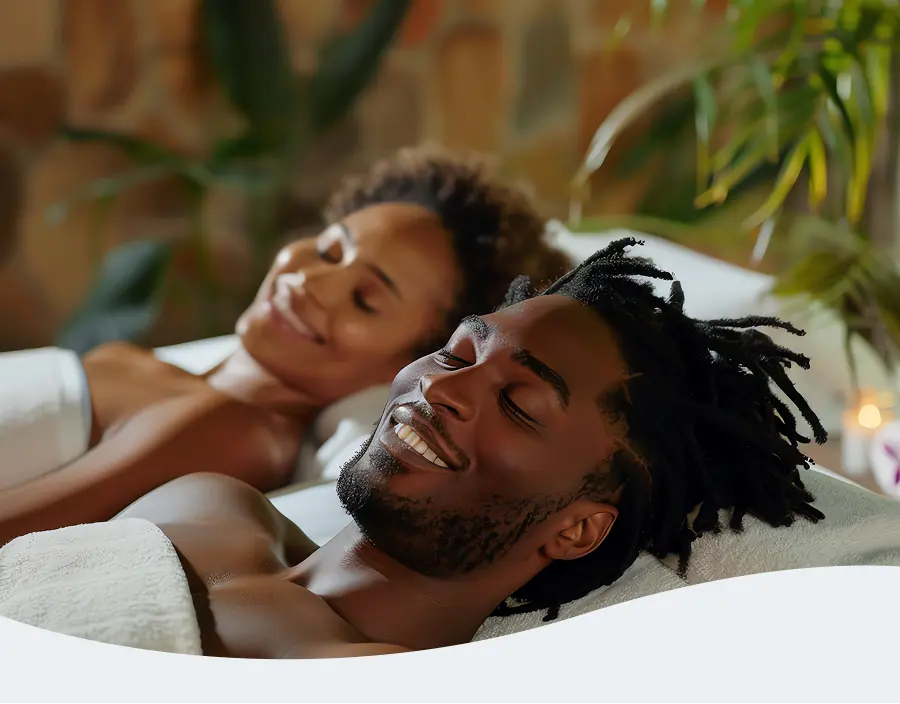 African man and woman wrapped in towels enjoying a spa day together