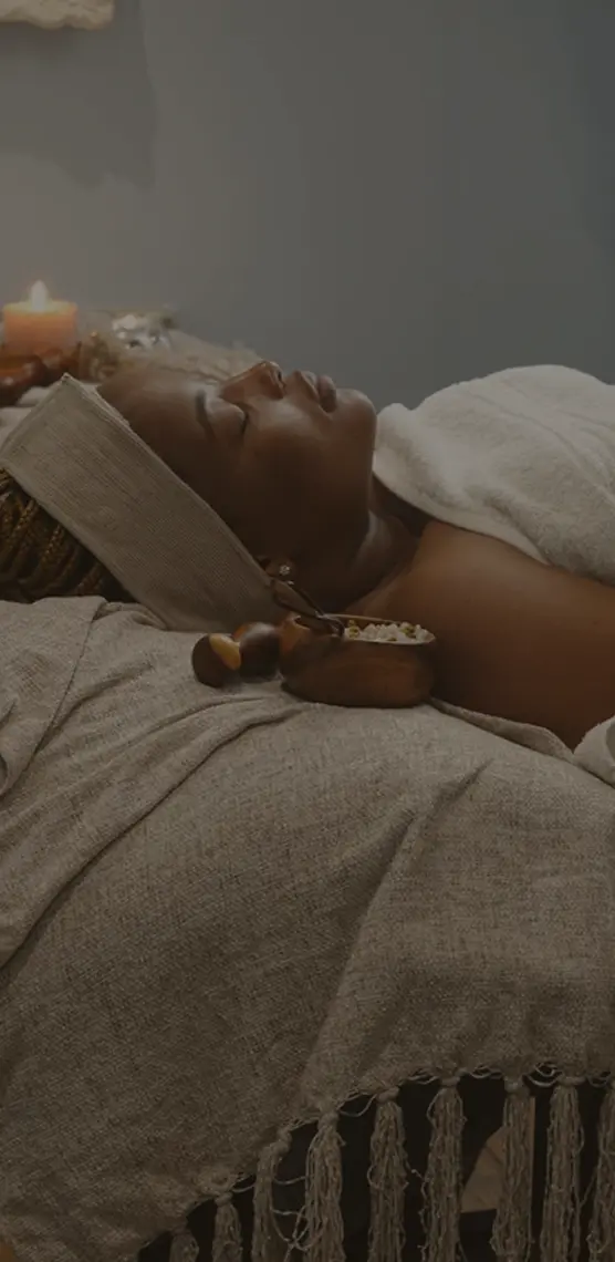 Picture of an african woman getting a facial massage at Pause Spa